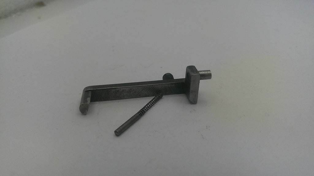 Metal tool with a screw on a light gray background