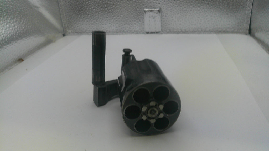 Black cylindrical object with multiple nozzles on a white surface