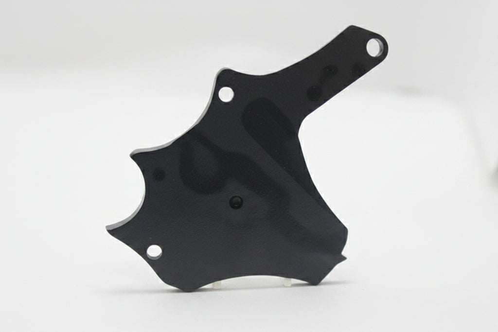 A small black plastic or metal hardware piece with three screw holes, shown standing on a white surface against a white background.