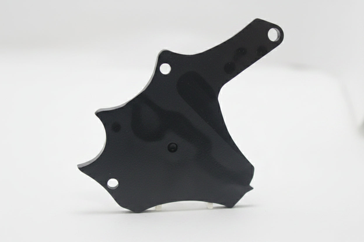 A small black plastic or metal hardware piece with three screw holes, shown standing on a white surface against a white background.