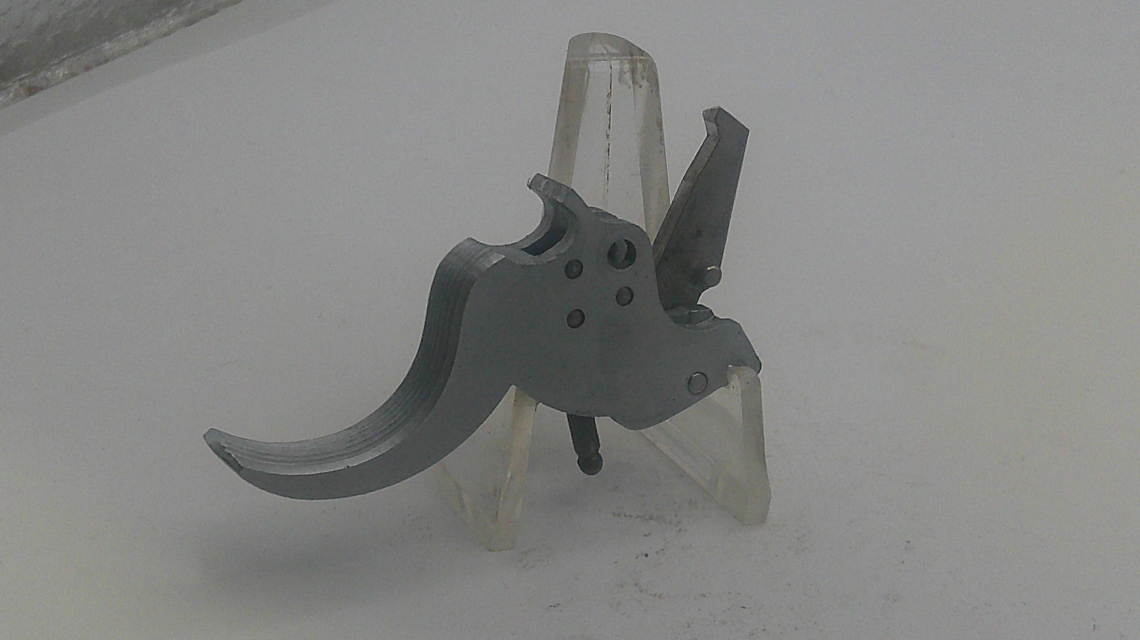 Metallic firearm component on a white background