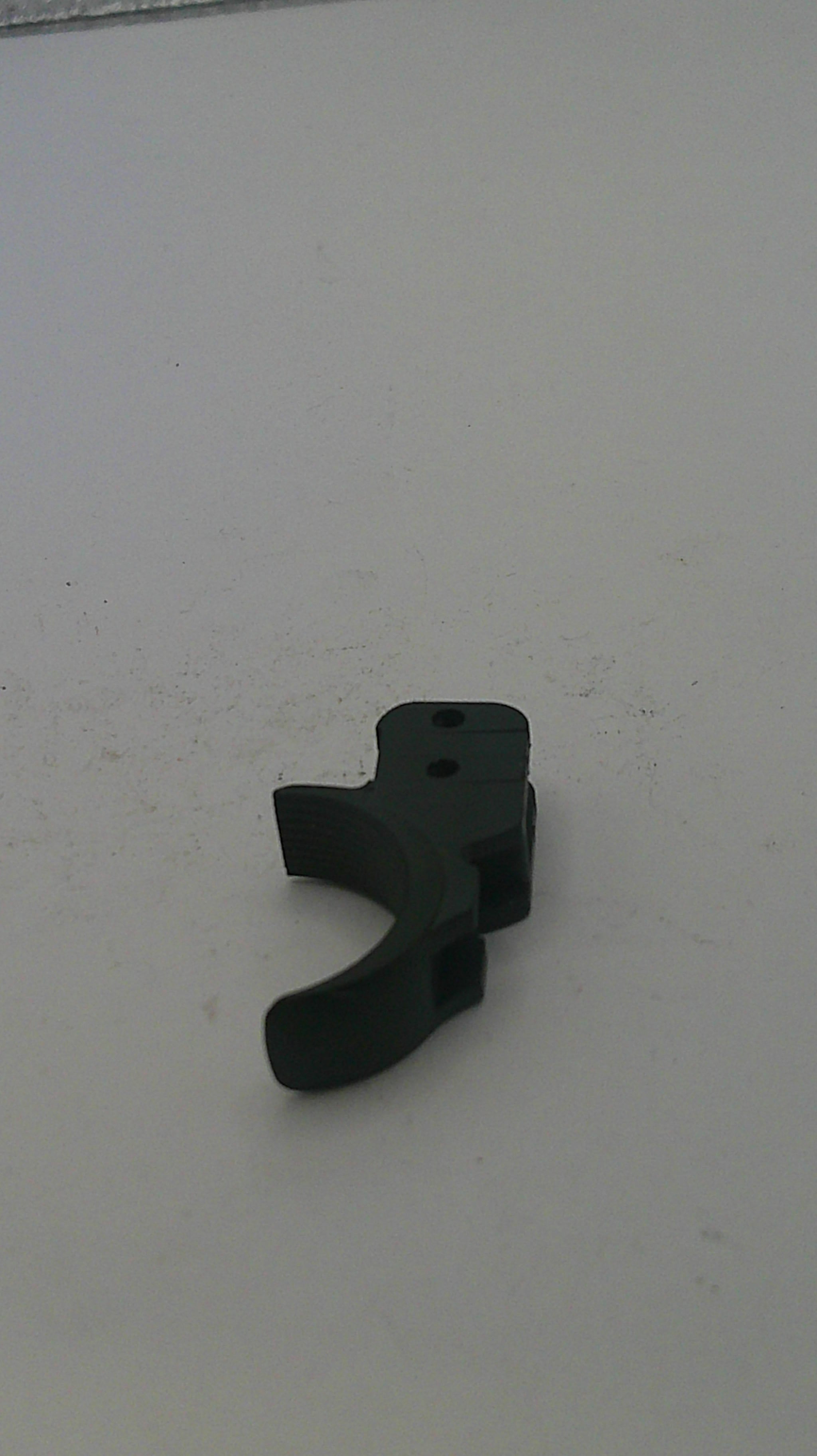 Black plastic component on a white background
