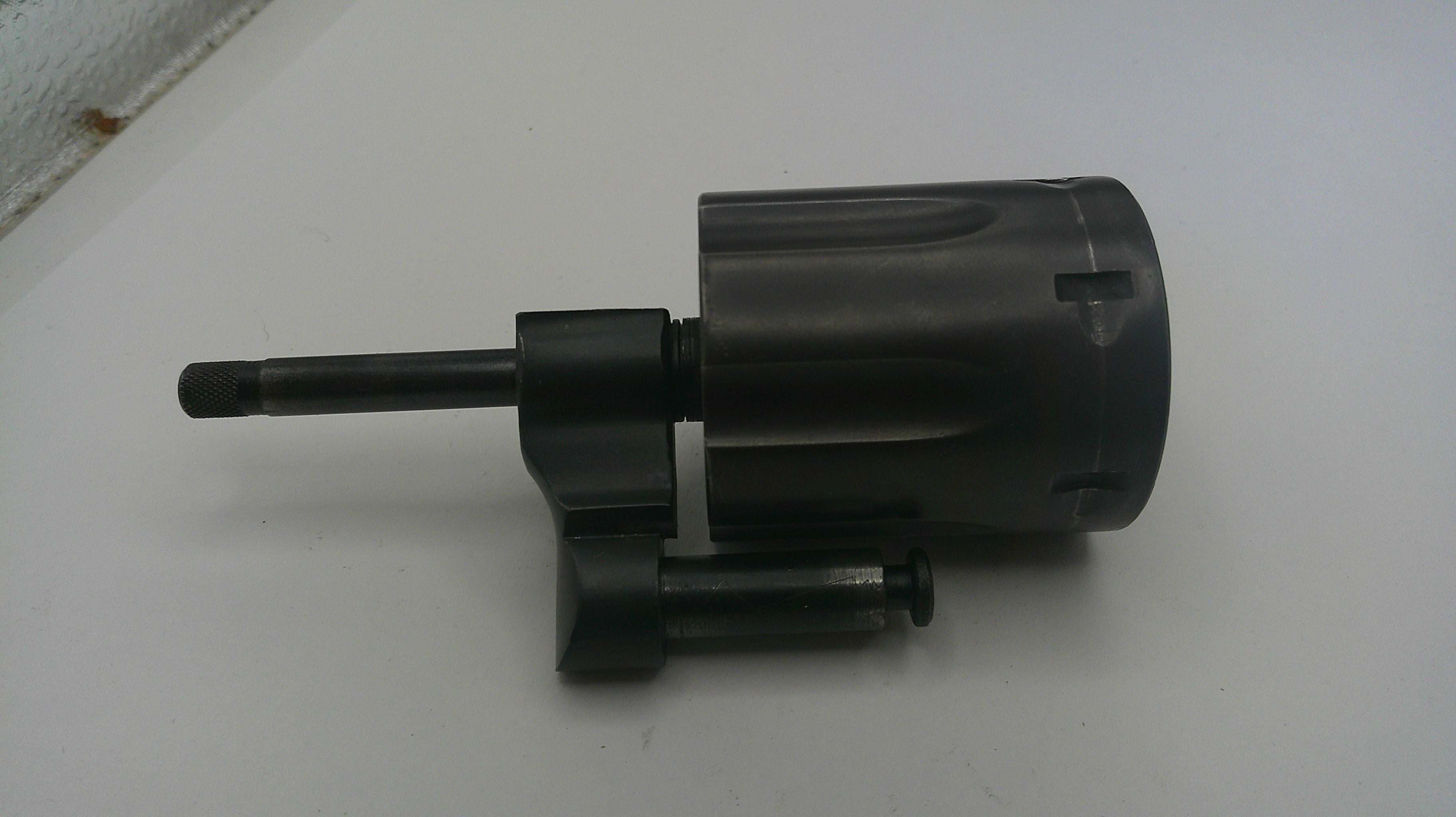 Black mechanical component on a white surface