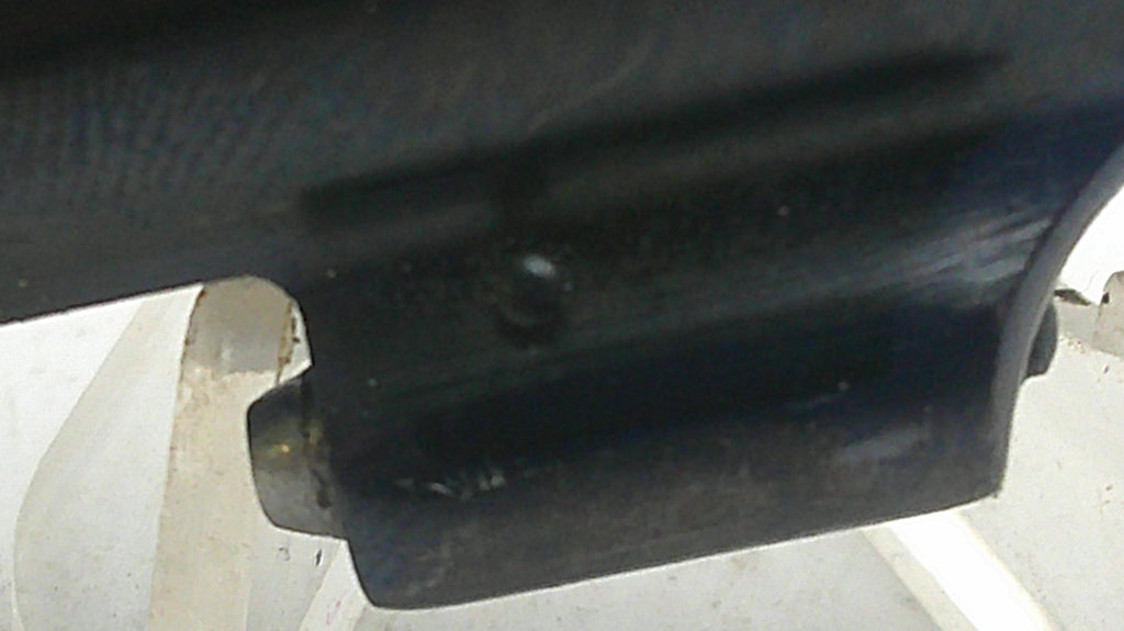Close-up of a car exhaust system with a focus on the muffler.