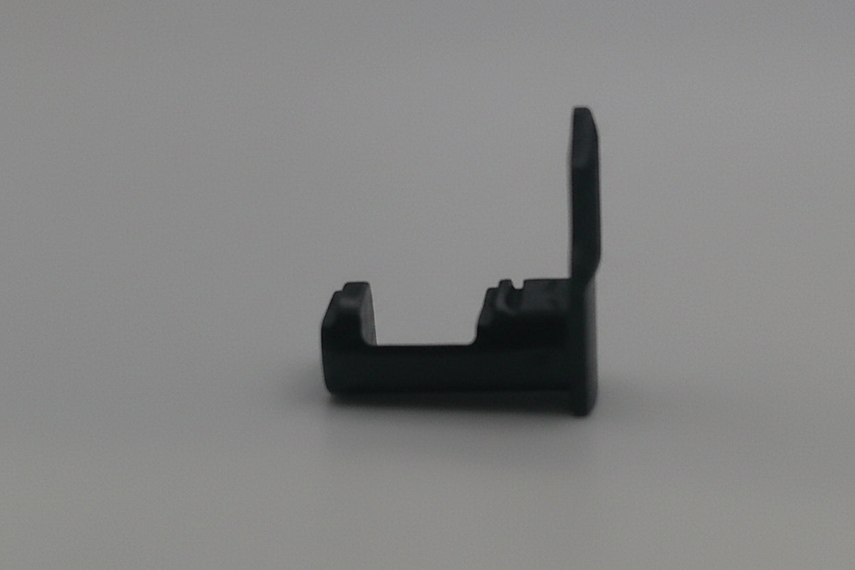 Black plastic component on a white background