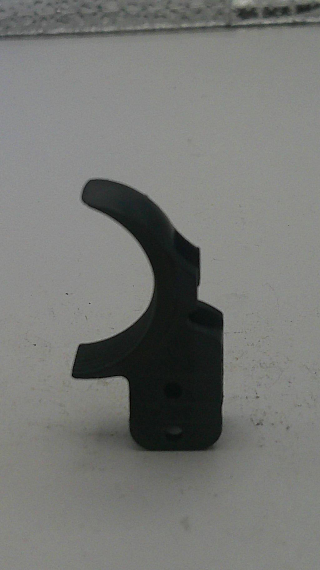 Black metal component on a white background