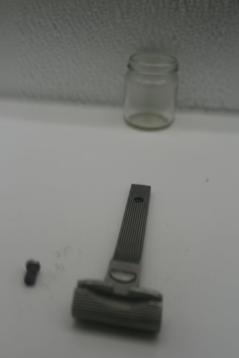 Close-up of a door handle on a white door with a textured gray surface.
