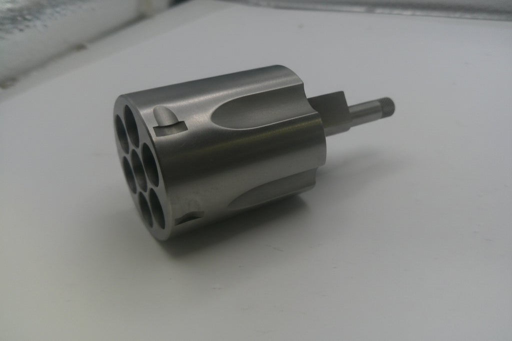 Metal cylindrical component on a white surface