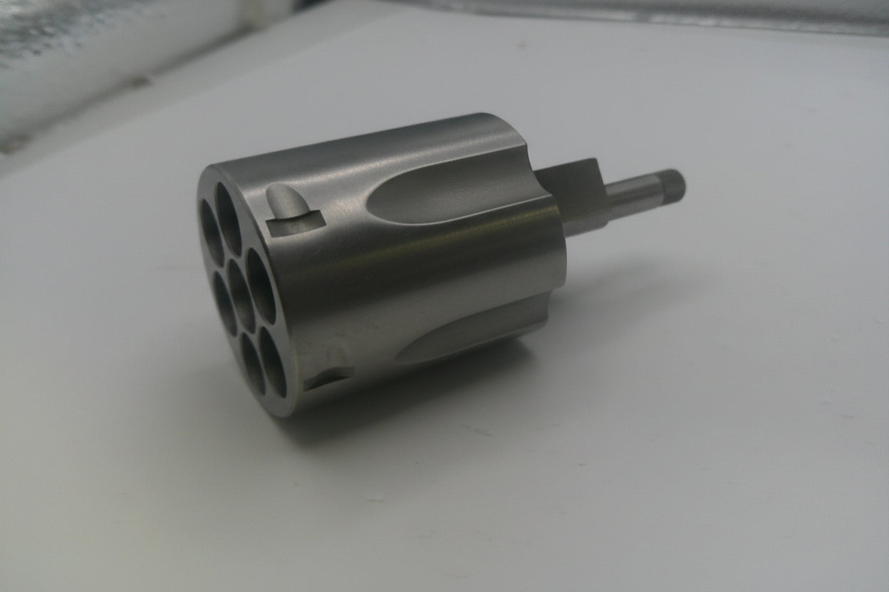 Metal cylindrical component on a white surface