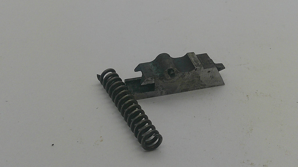 A small mechanical replacement part consisting of a dark metal spring and a matching metal bracket, shown on a plain off-white background.