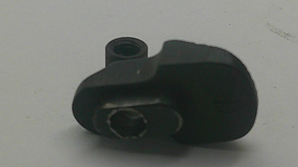 A small black plastic hardware component with threaded holes, photographed on a plain light gray surface.
