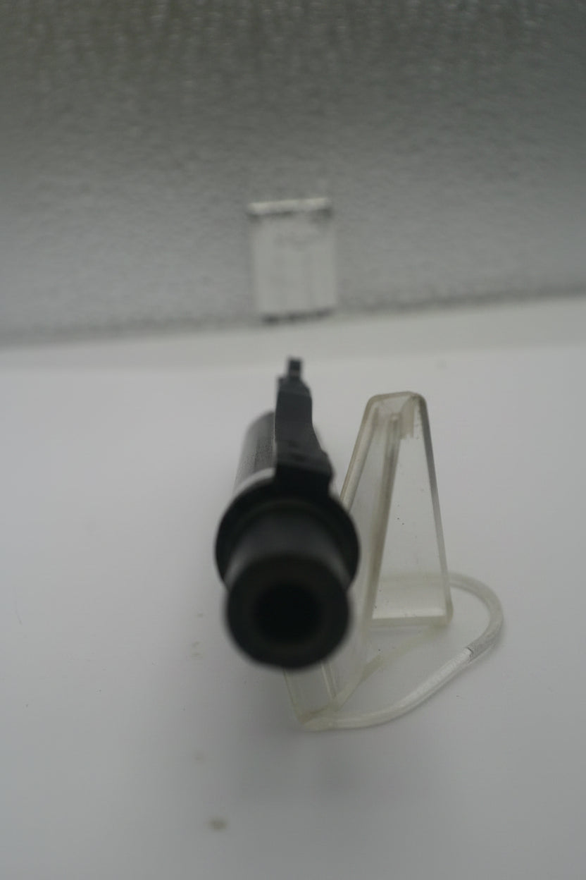 Blurred image of a black object on a white surface