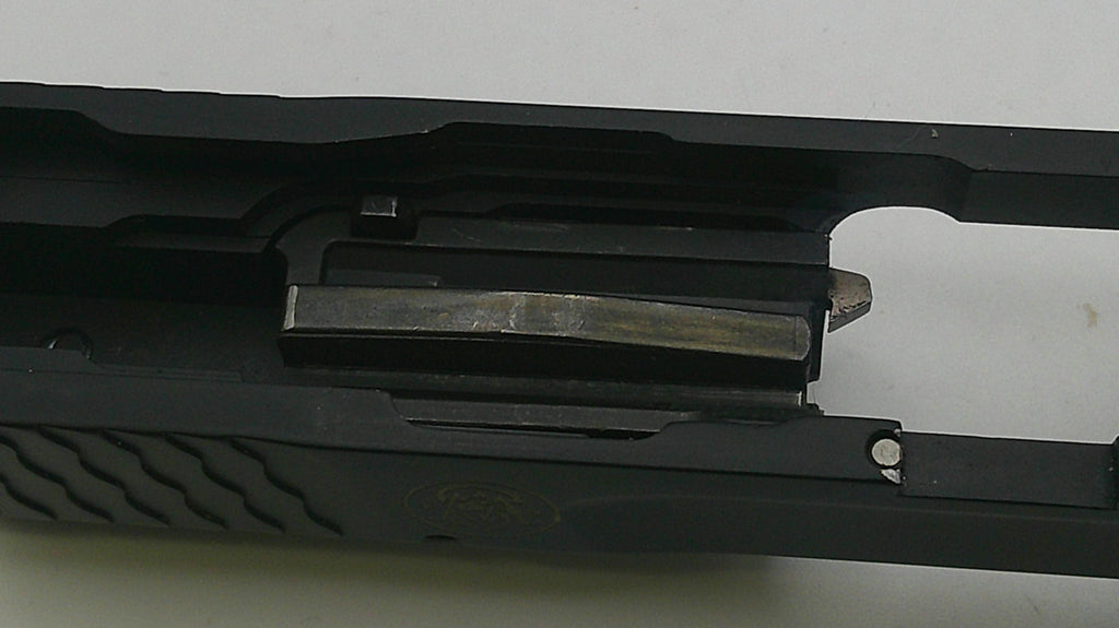 Close-up of a black gun slide on a white background