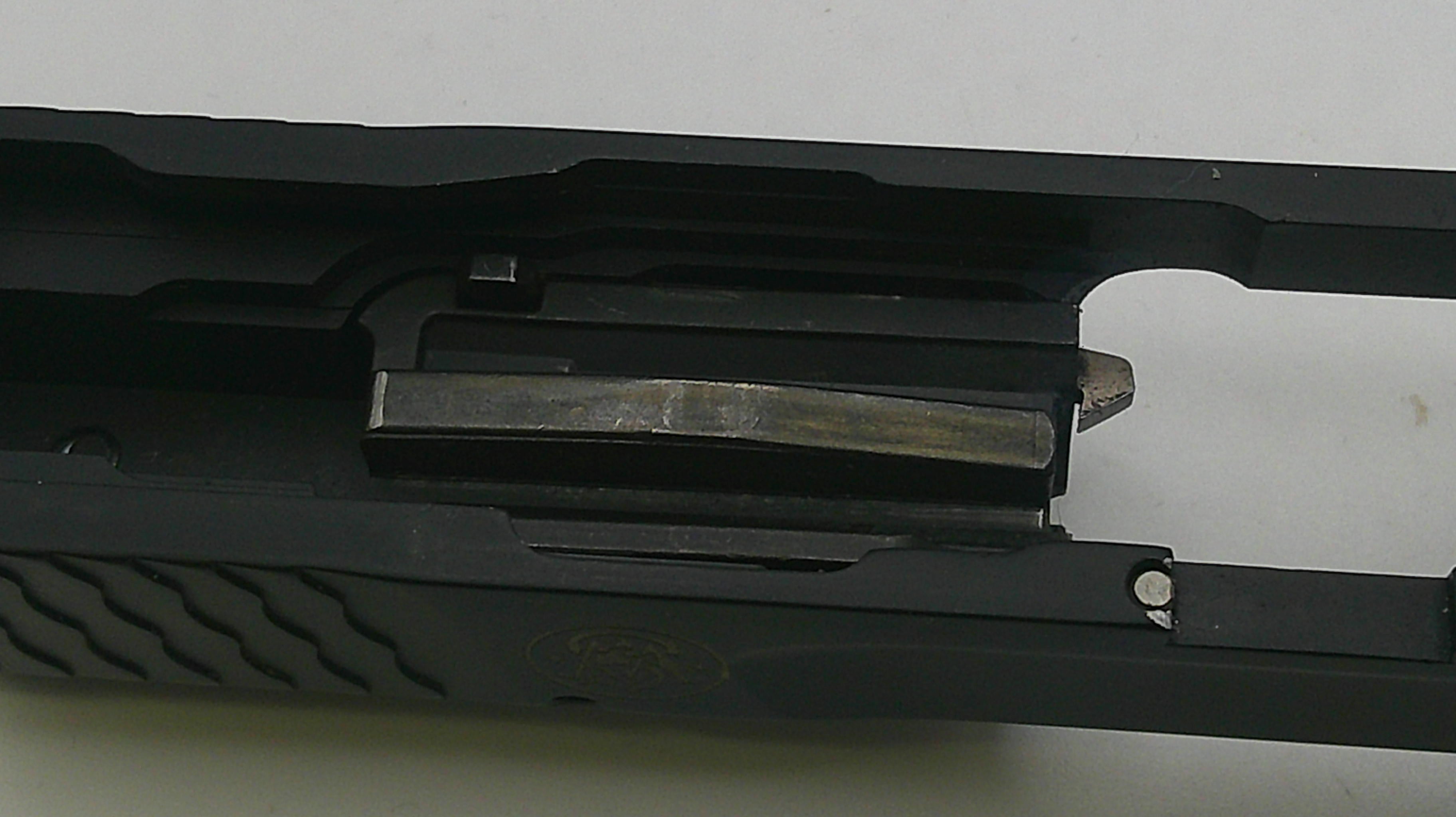 Close-up of a black gun slide on a white background