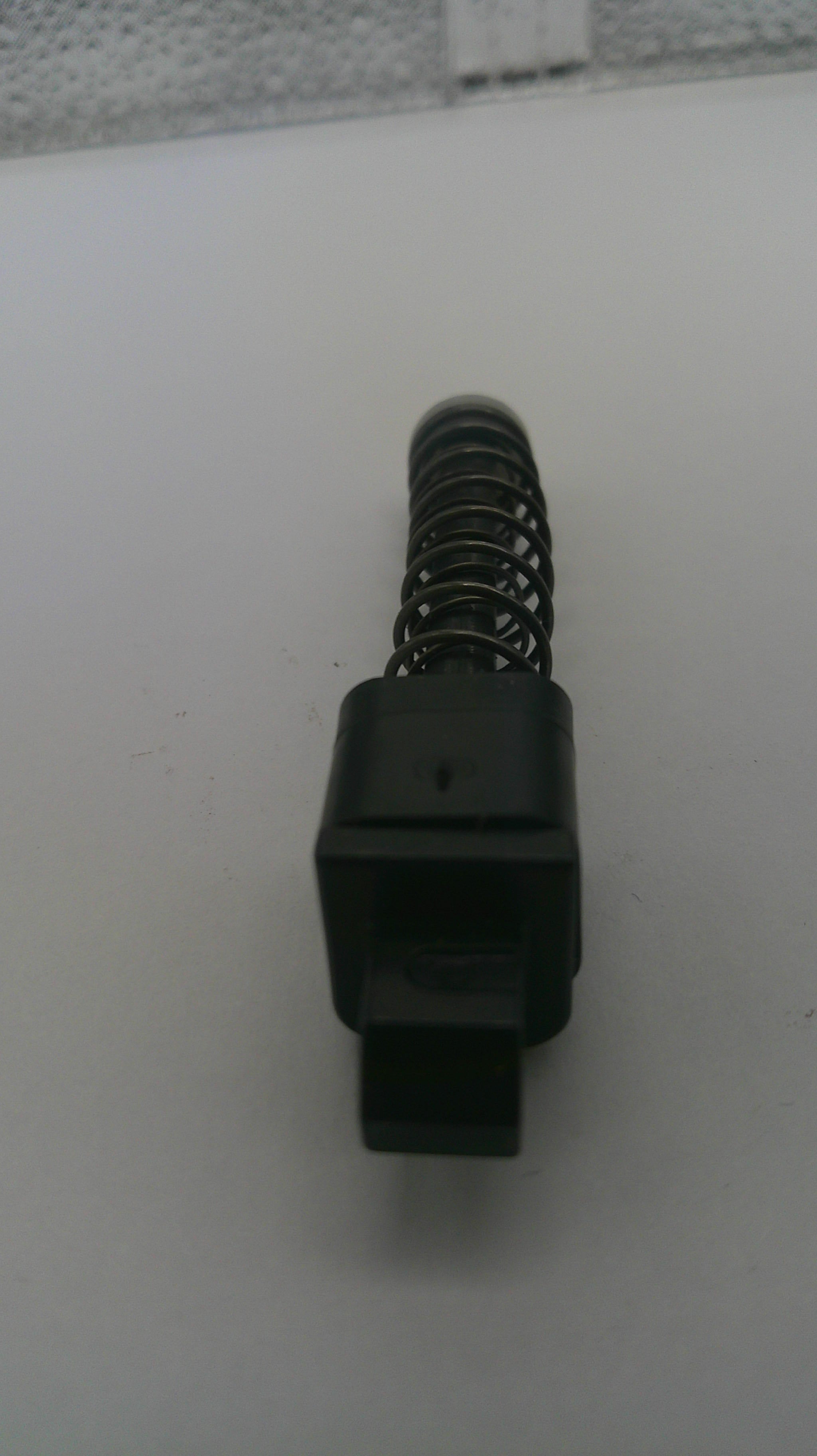 Black spring-loaded mechanism on a white background