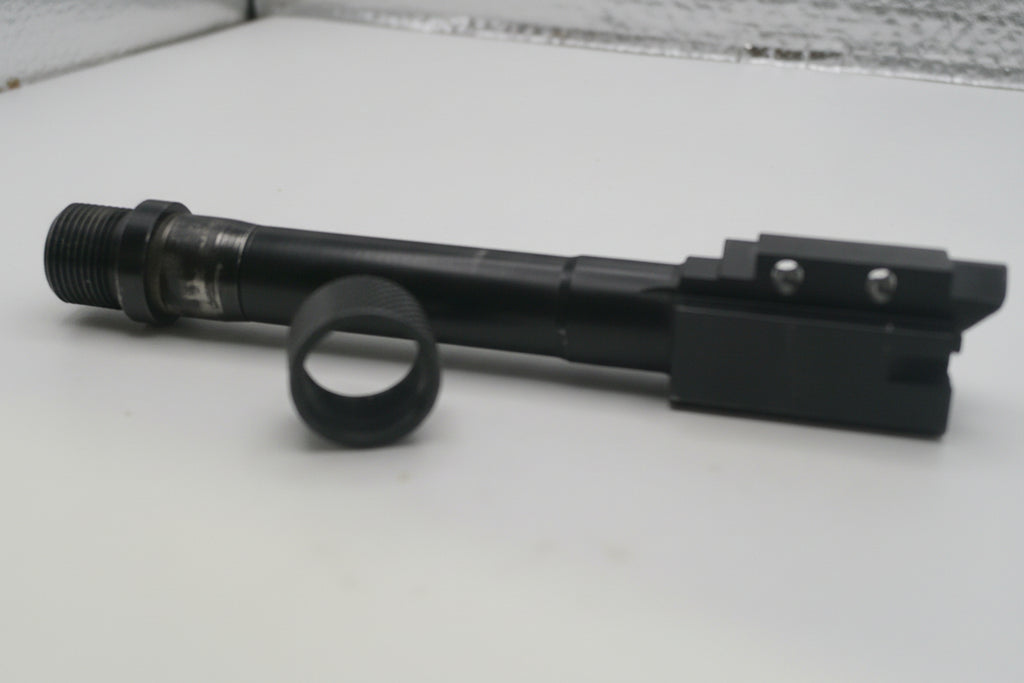 Black rifle scope on a white surface