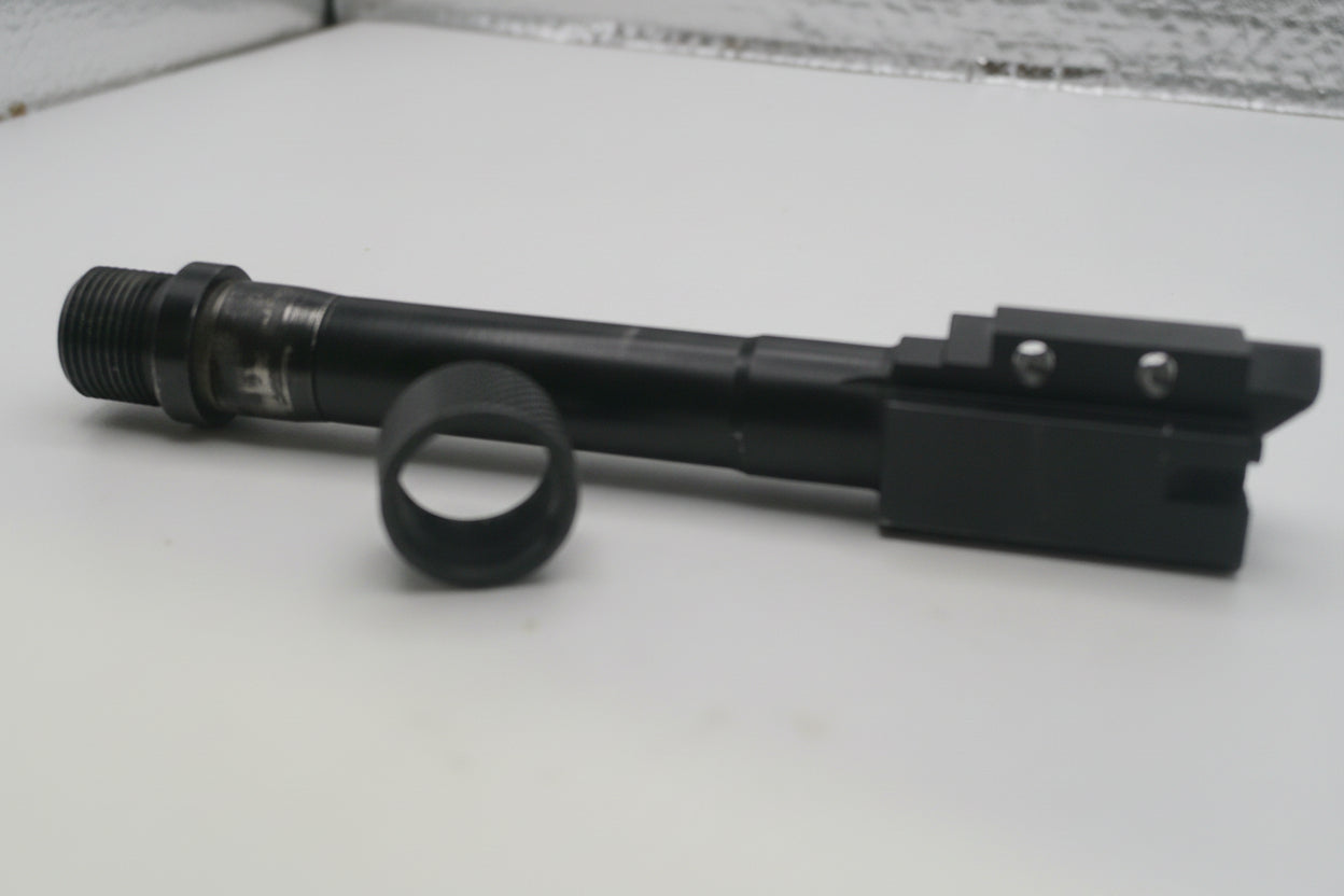 Black rifle scope on a white surface