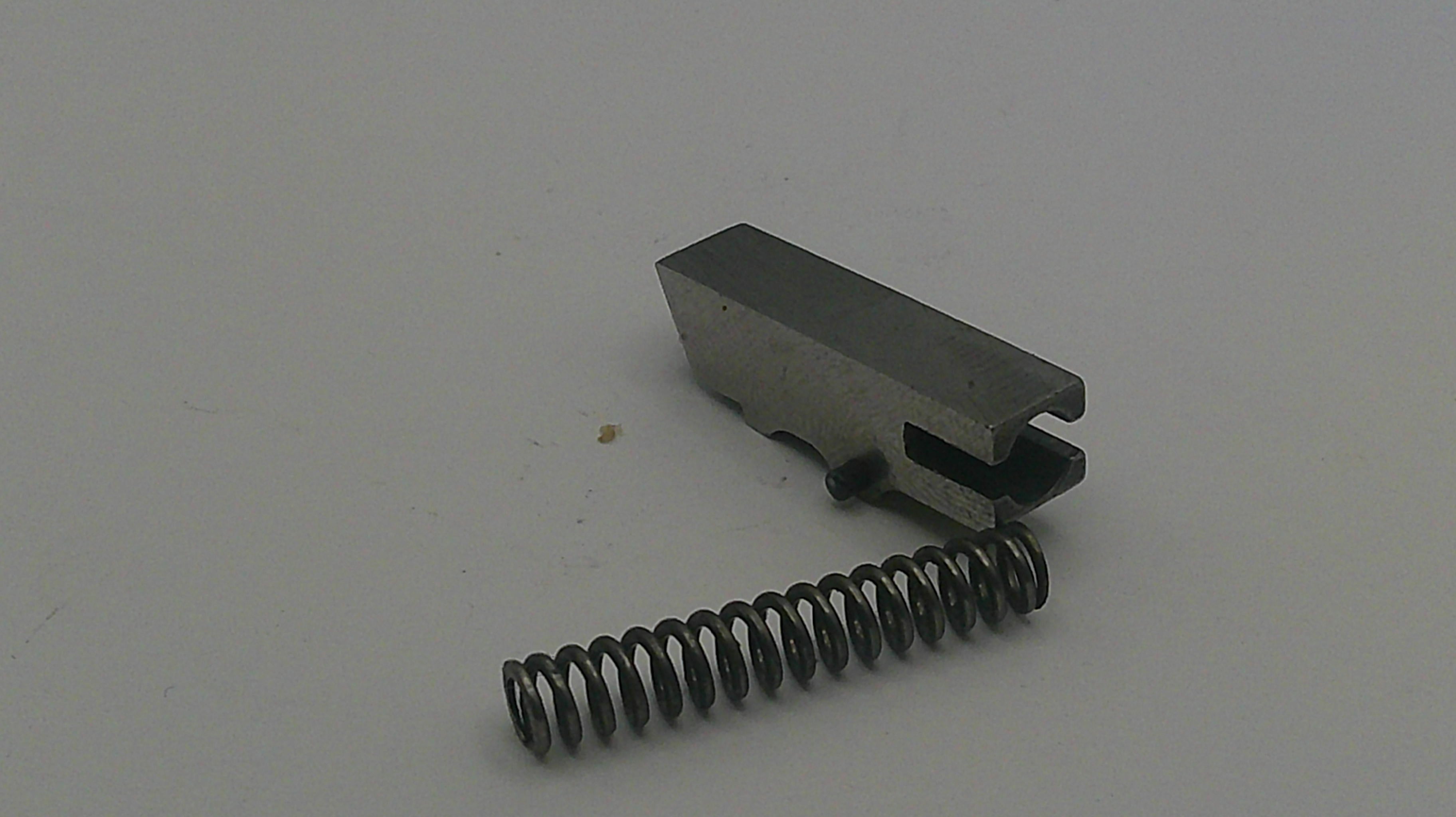 Metal component with a spring on a white background