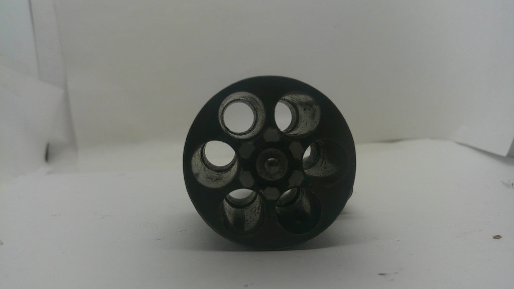 A black circular wheel or pulley with six circular cutouts, photographed on a plain white background.