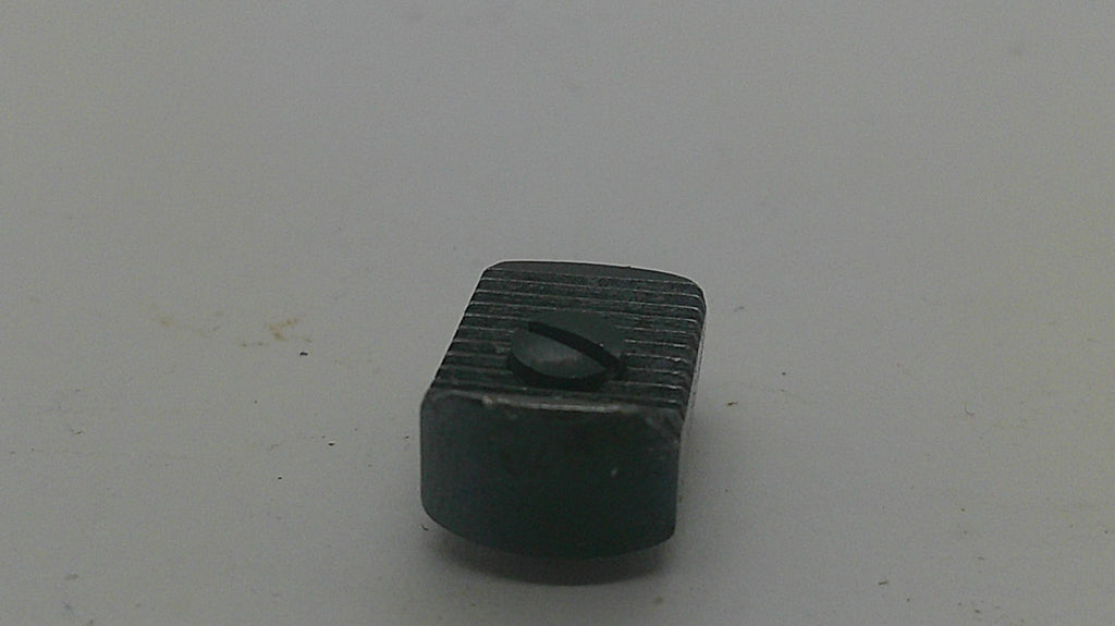 A small black rectangular plastic component with a ribbed top surface and a small oval cutout, shown on a plain light gray background.