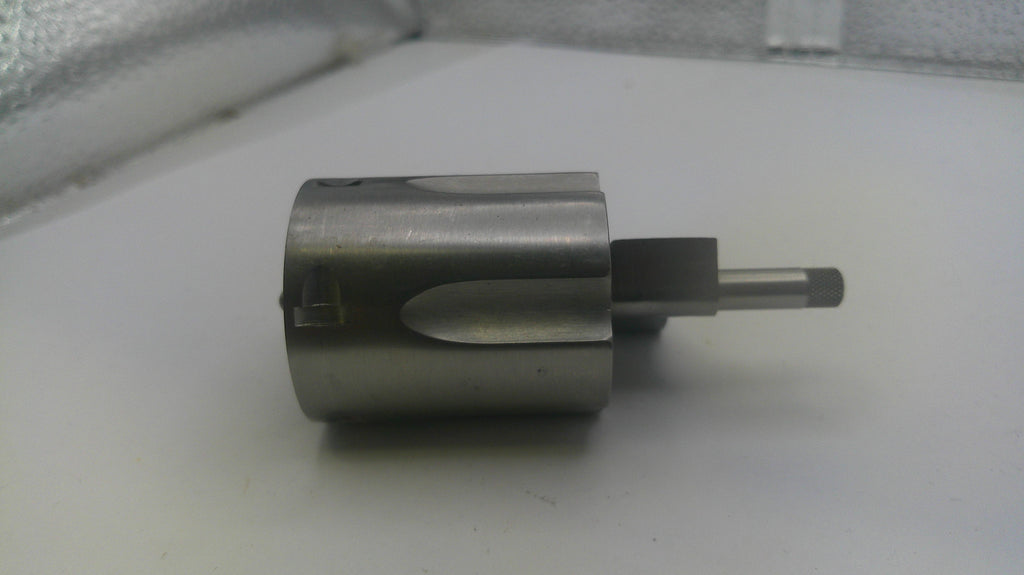 Metal cylindrical component on a white surface