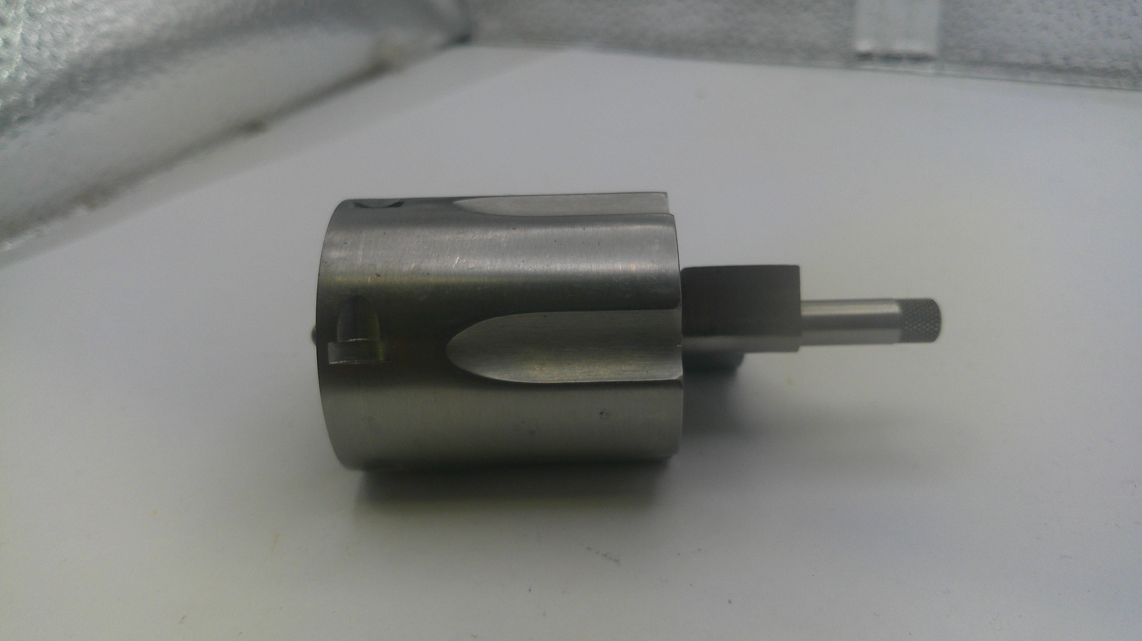 Metal cylindrical component on a white surface