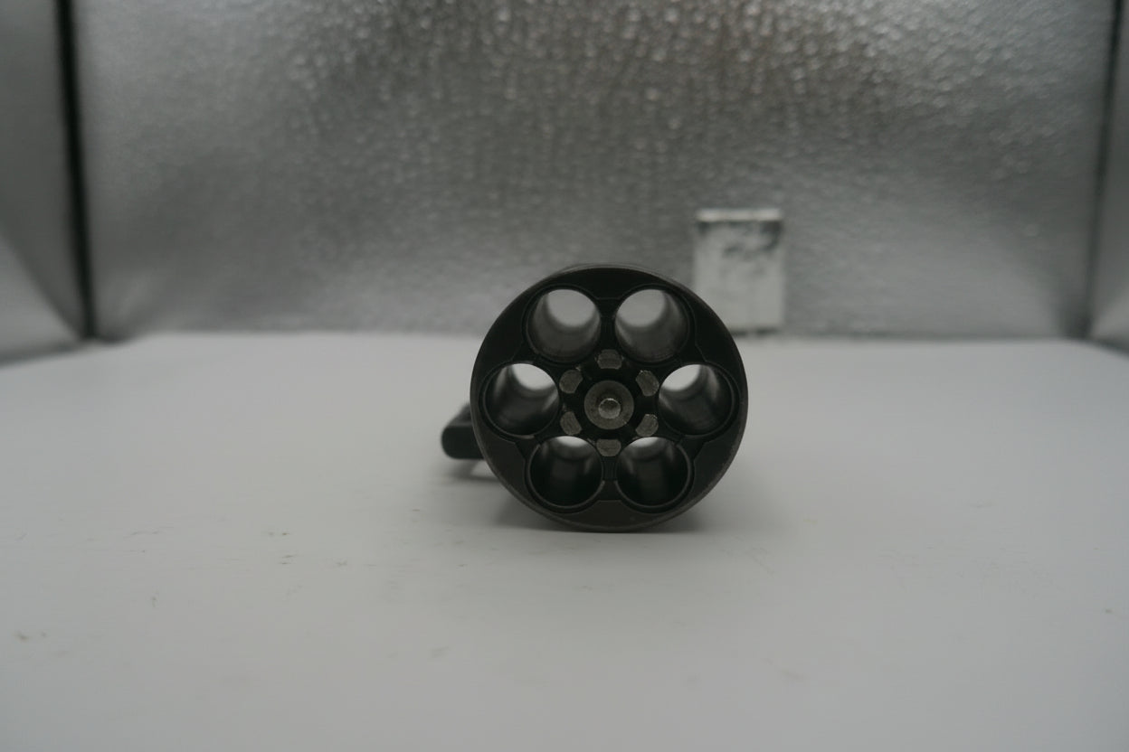 Black cylindrical object on a textured surface