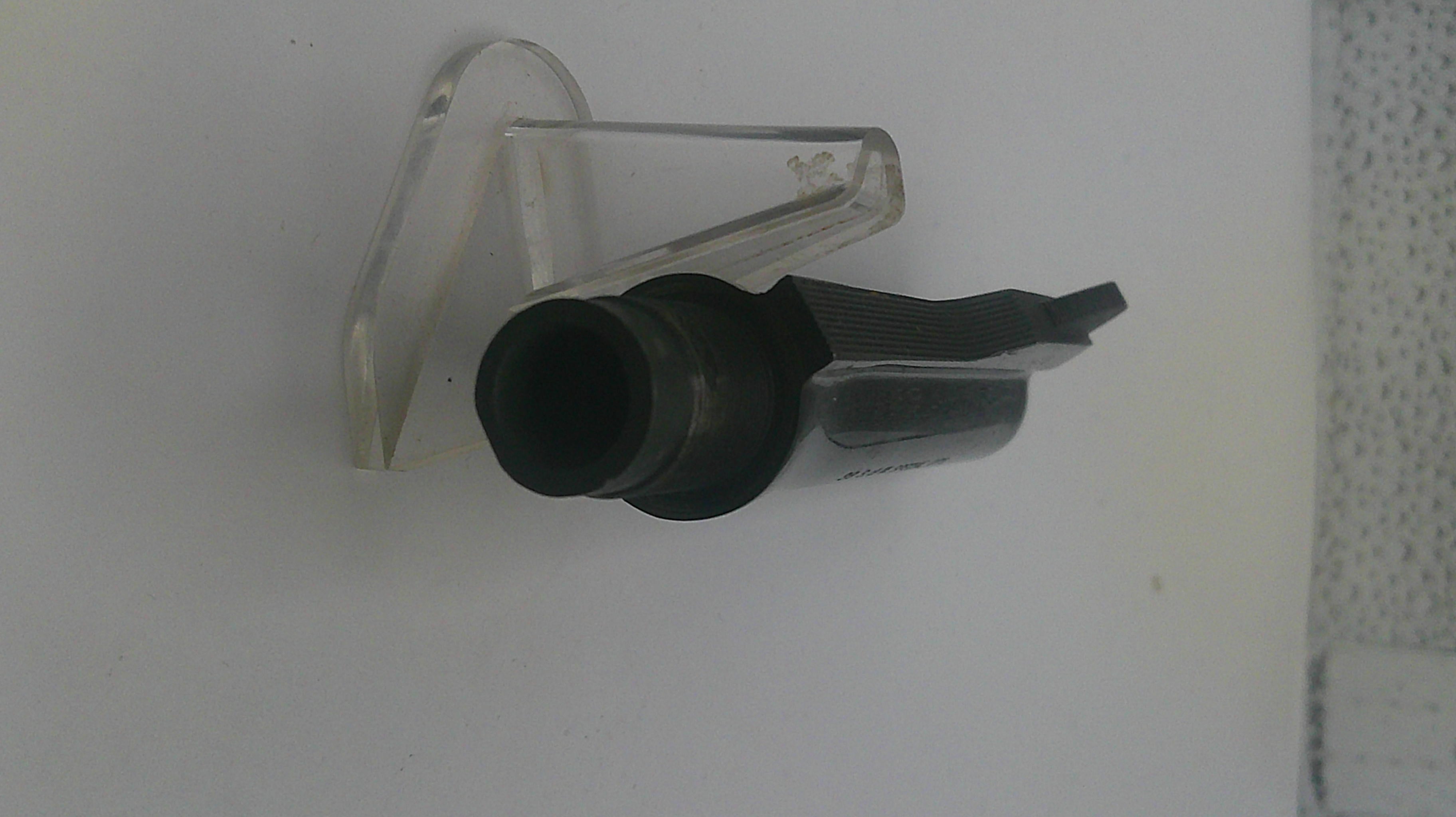 Black and clear plastic component on a white background