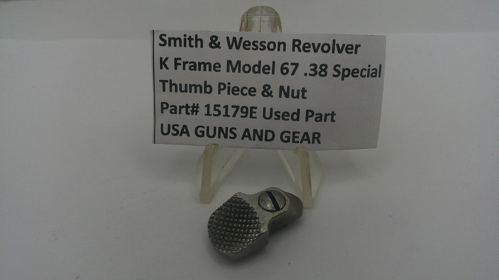 Smith & Wesson revolver thumb piece and nut on a stand with a label