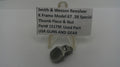 Smith & Wesson revolver thumb piece and nut on a stand with a label