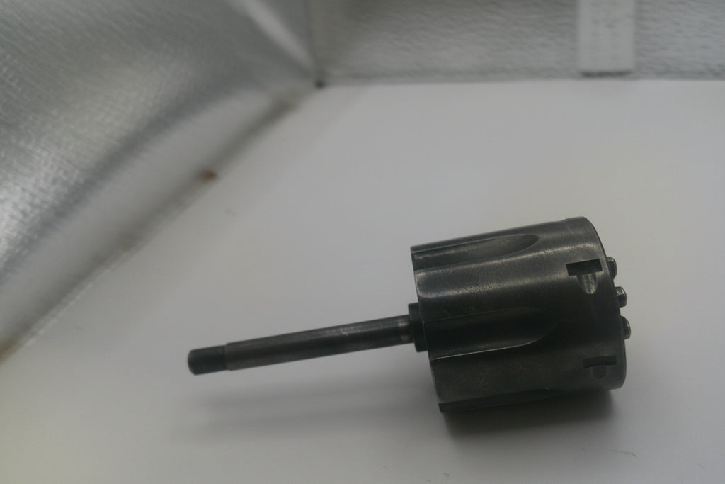 Black cylindrical brush on a white surface with a metallic background