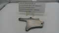 Smith & Wesson revolver side plate on a white surface with a label.