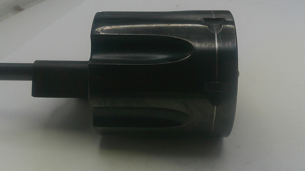 Black cylindrical object with a handle on a light gray background