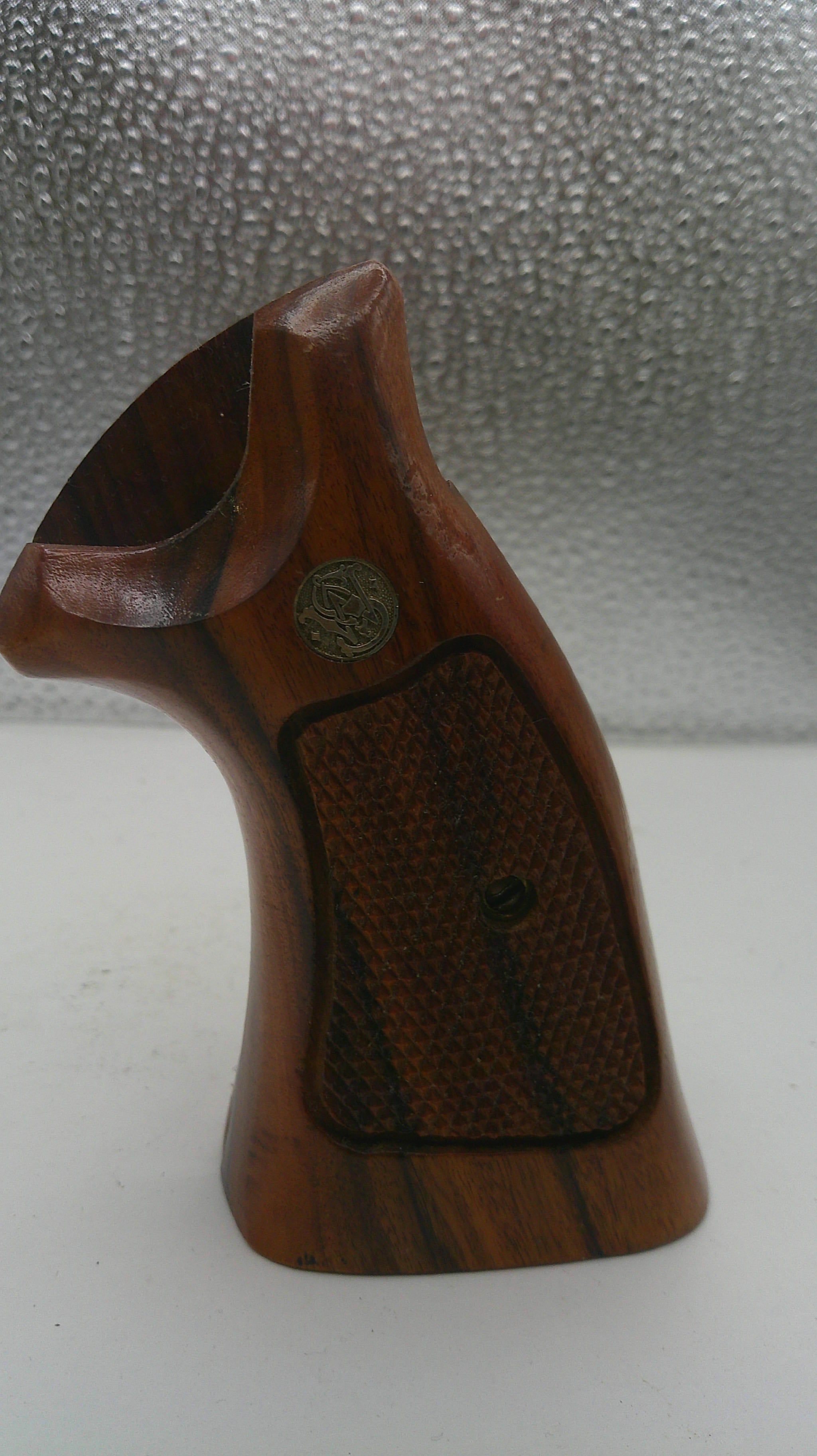 Wooden gun stock on a textured surface