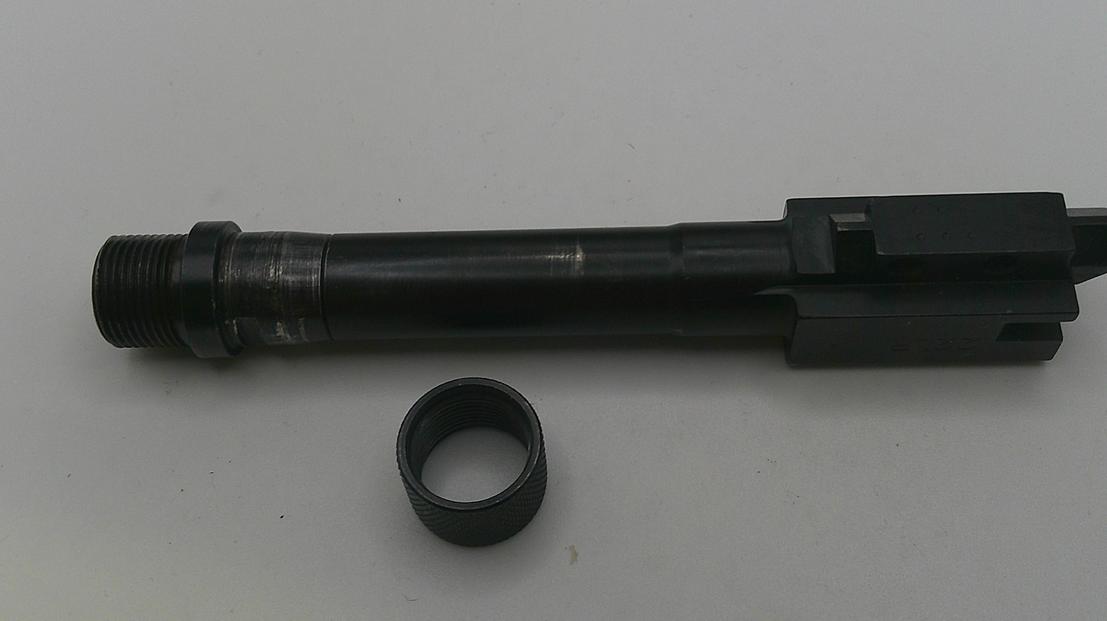 Black cylindrical metal component with a smaller ring on a gray background