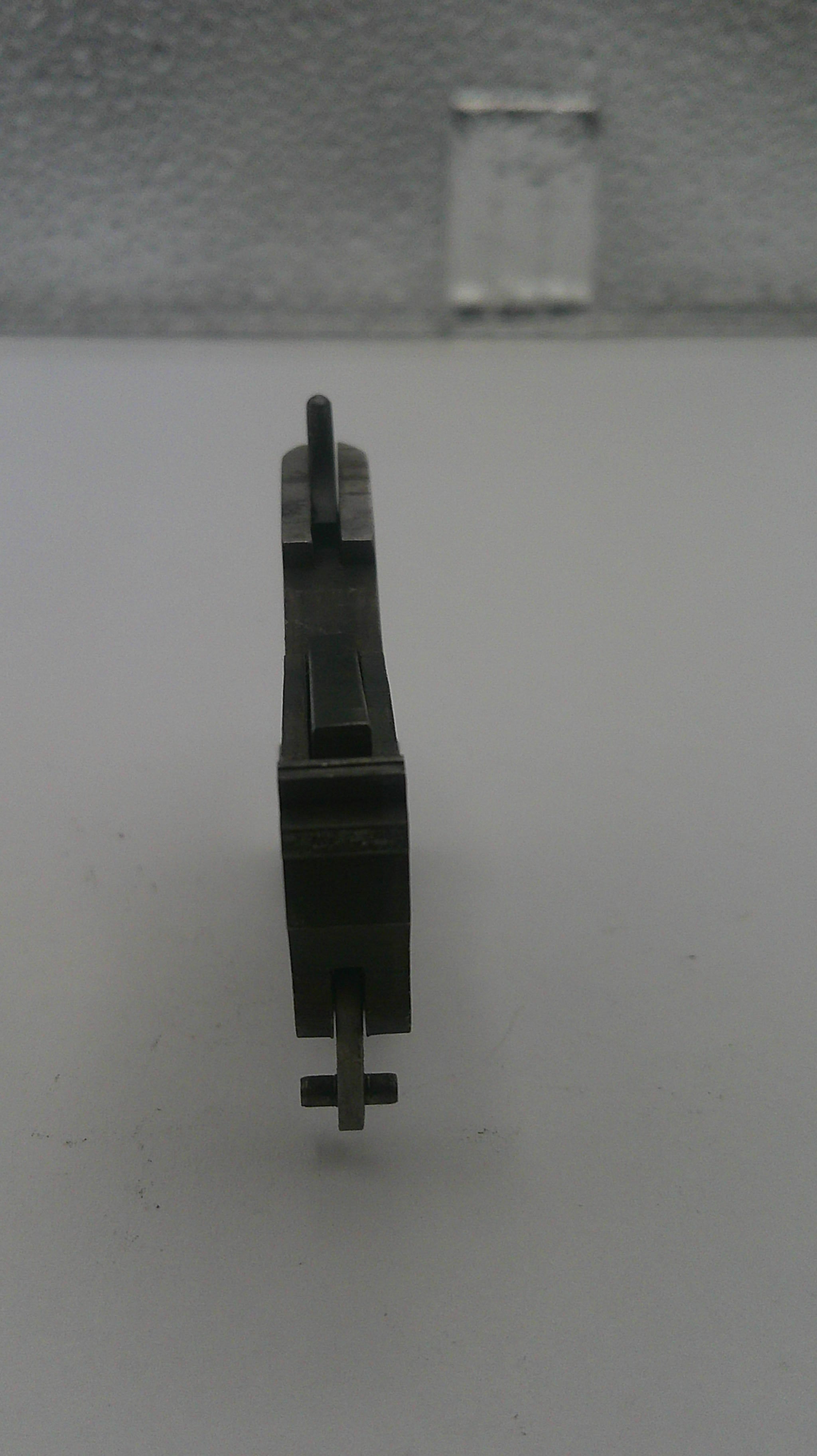 Black metal component on a white background