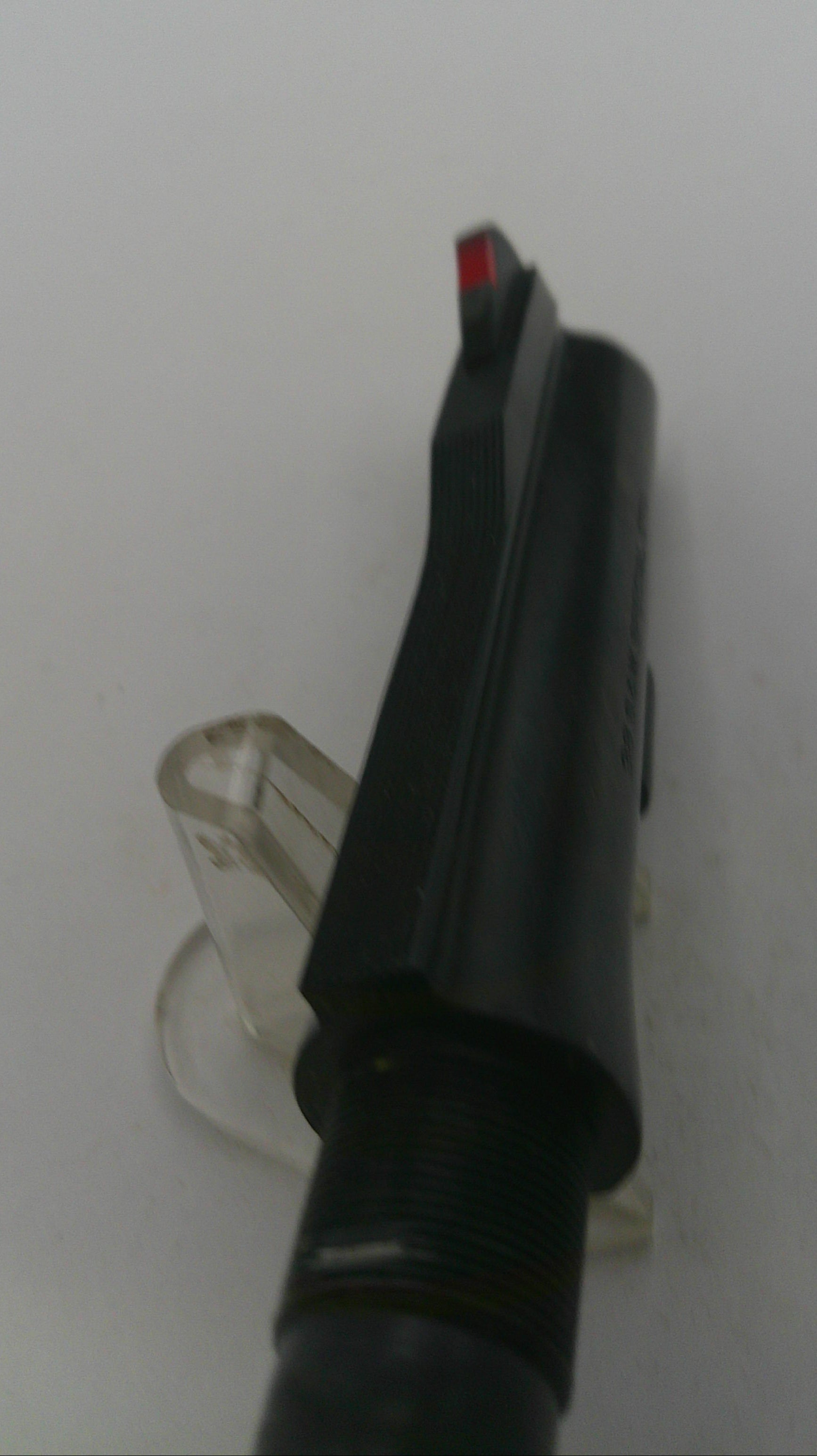 Black plastic component on a white background