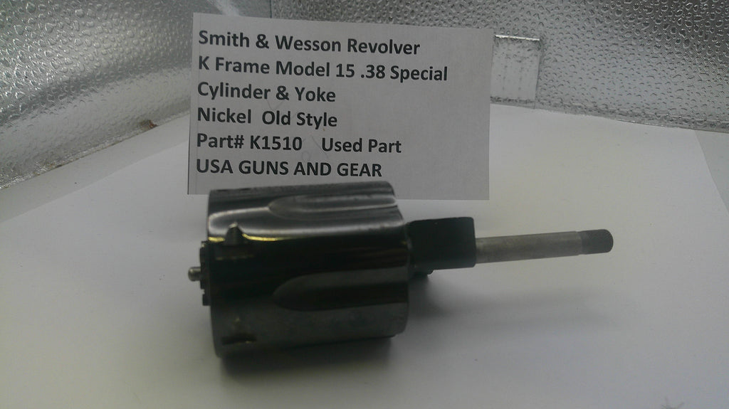 Smith & Wesson revolver part on a white surface with a label