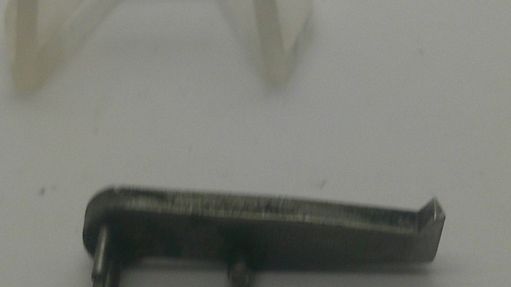 A small dark metal hardware component with a bent tip, shown on a plain light background.