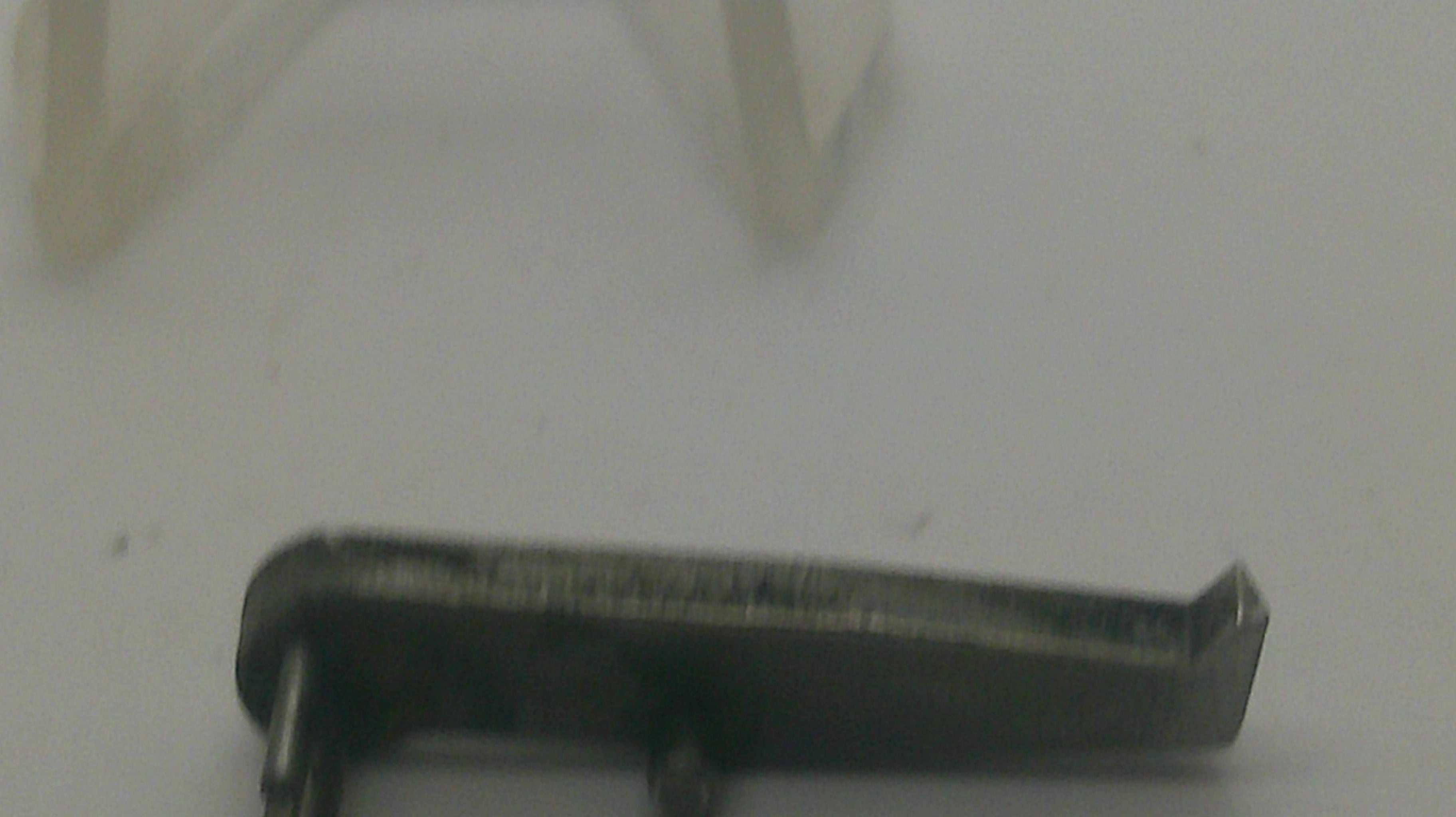 A small dark metal hardware component with a bent tip, shown on a plain light background.