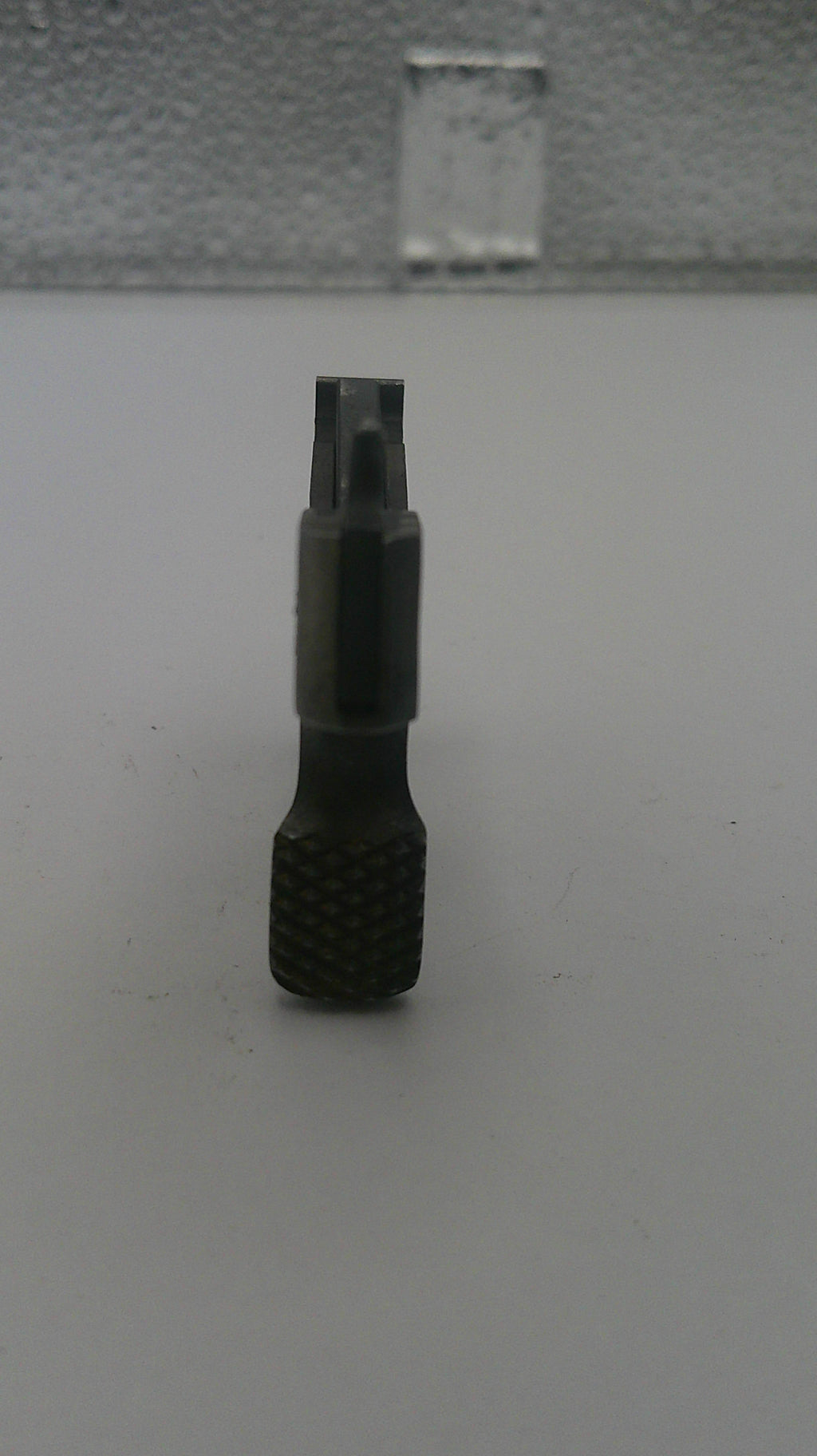 Black screwdriver bit on a white background