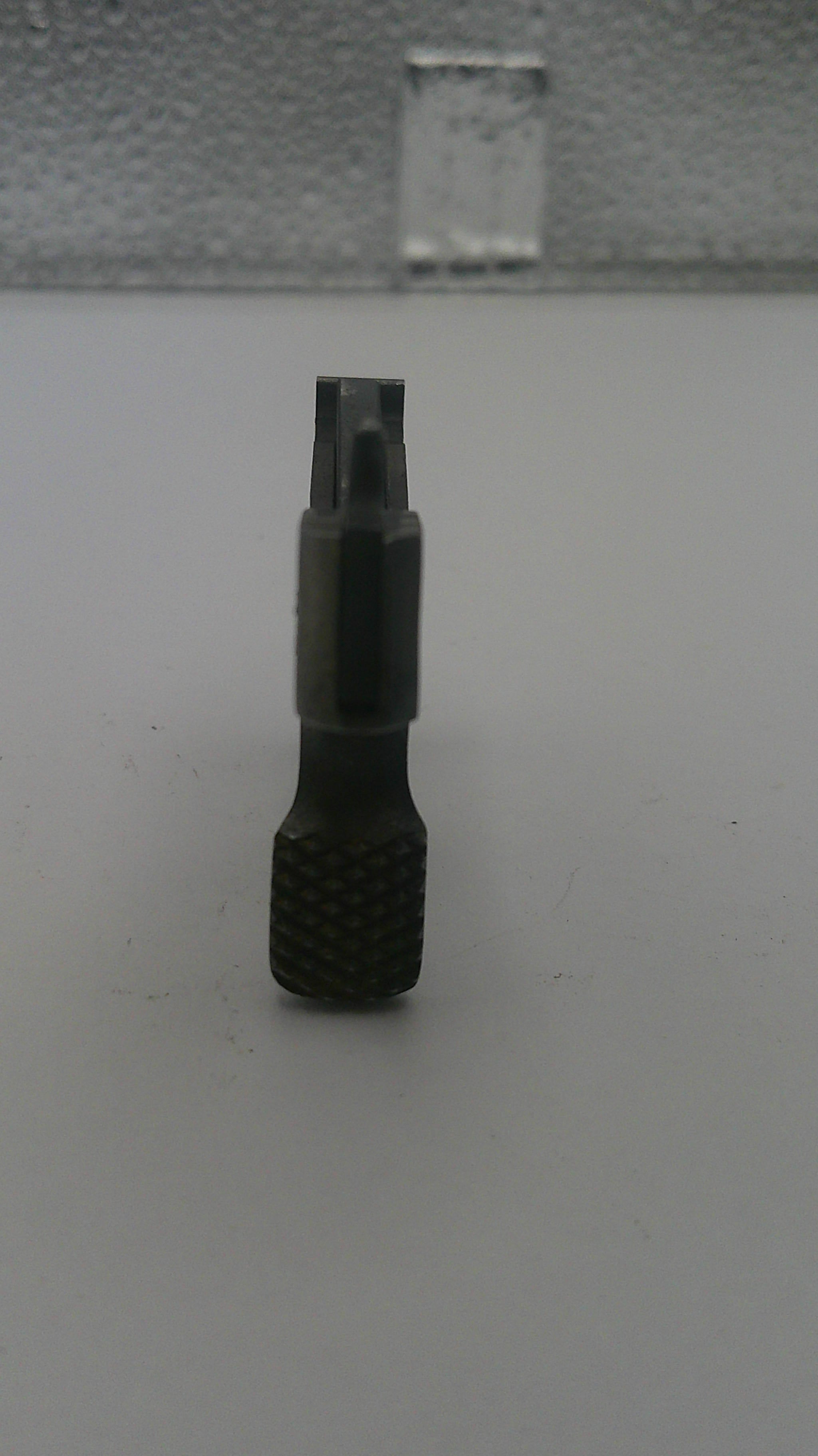 Black screwdriver bit on a white background