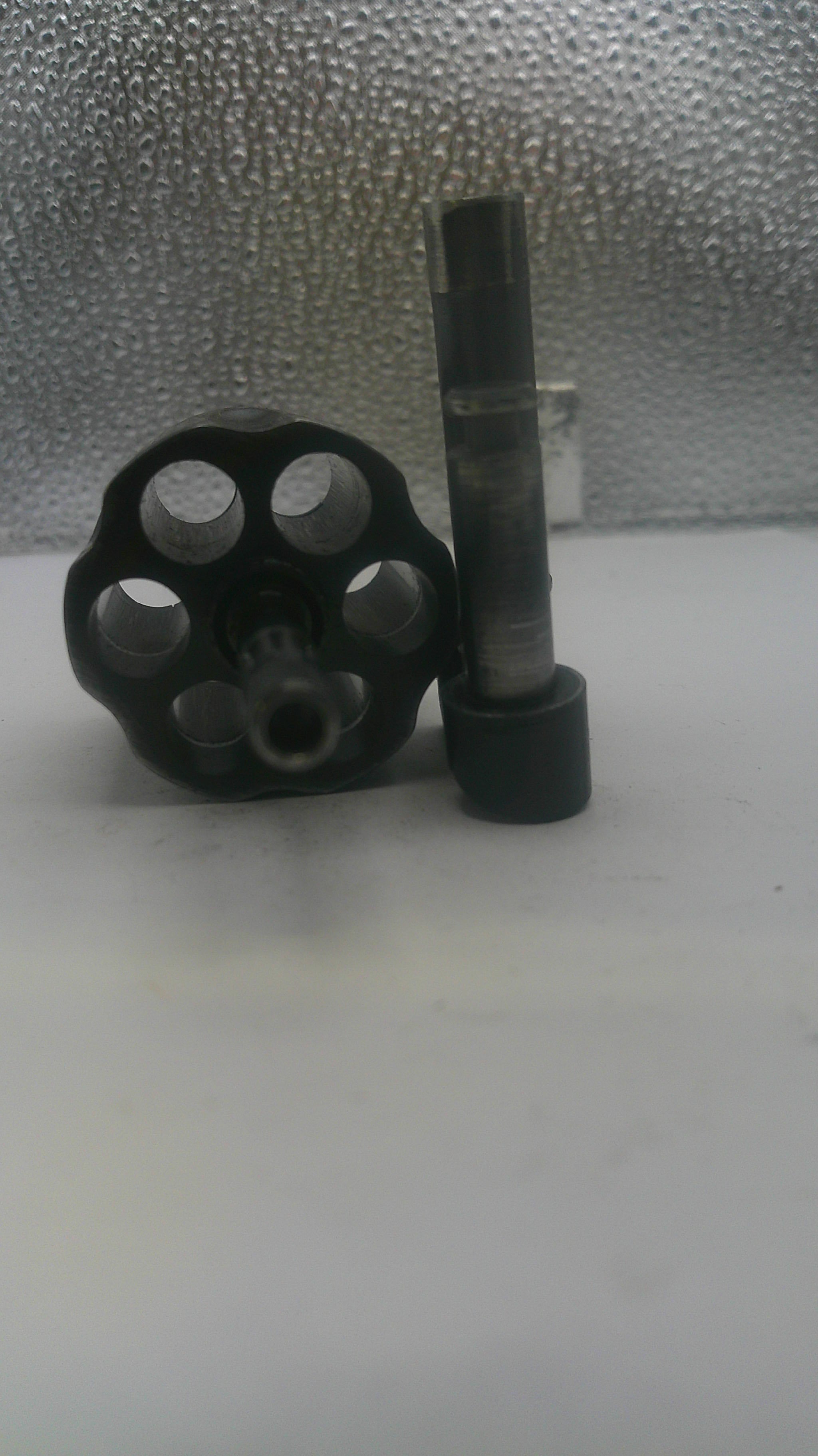 Black metal valve handle on a white background