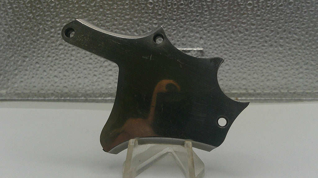 Metallic object on a stand against a textured gray background