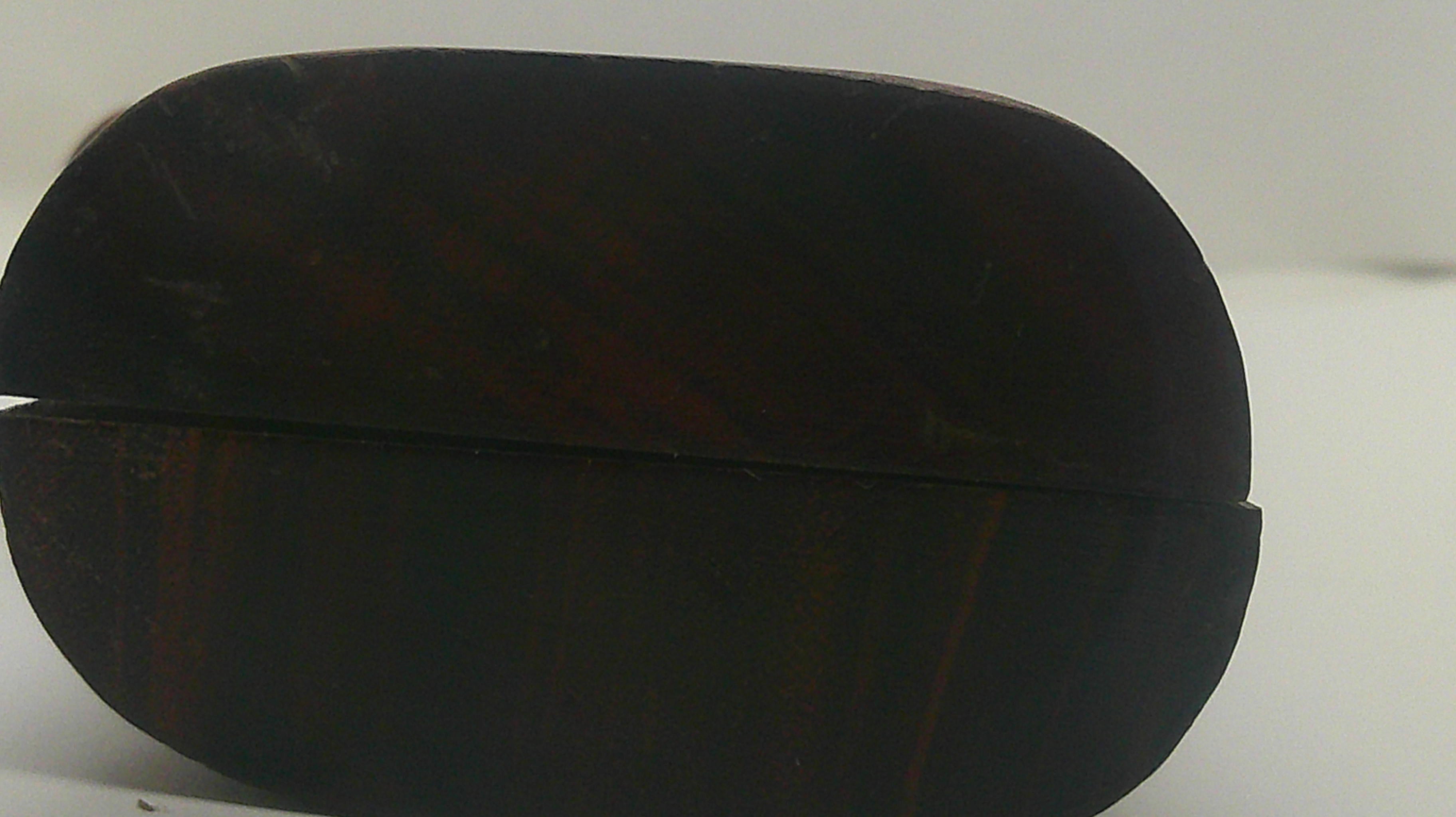 A dark brown wooden oval box with a polished finish, shown closed on a plain light background.