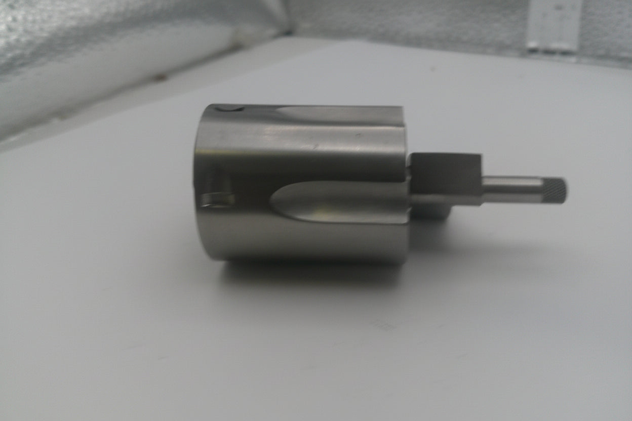 Metallic cylindrical object on a white surface