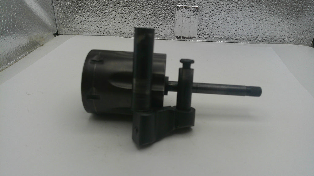 Black mechanical component on a white surface with a textured wall background