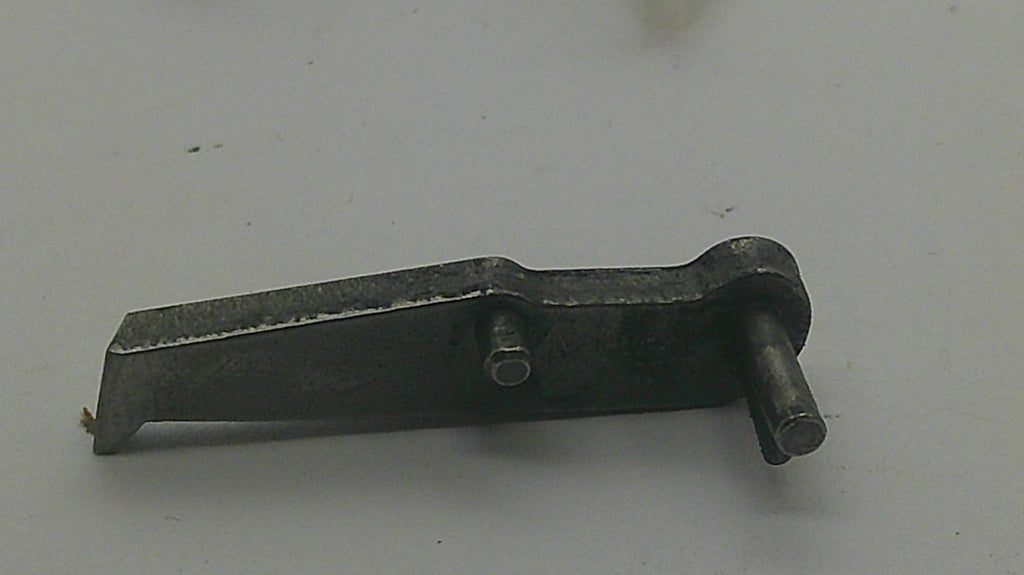 A small dark metal hardware component with a flat rectangular plate, a bolt hole, and a cylindrical pin, photographed on a plain light background.