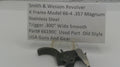 Smith & Wesson revolver part with descriptive label on a white background