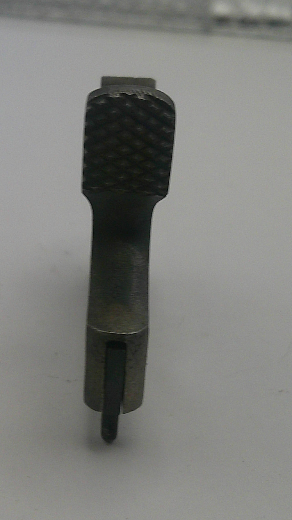Black metal tool bit on a white background